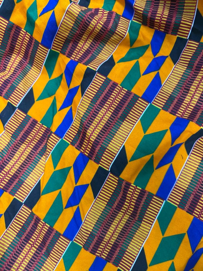 Heritage Elastic Kente Print Smocked Puff Sleeve Mermaid Maxi Gown. 4 A Woman Wearing An Heritage Elastic Kente Print Smocked Puff Sleeve Mermaid Maxi Gown.