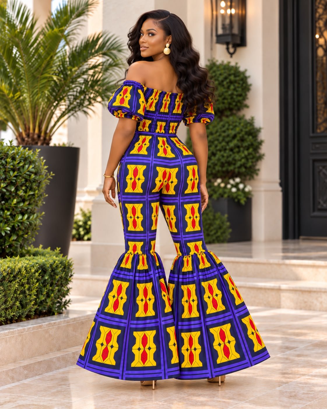 Royal Elastic Sapphire And Gold Samakaka Dramatic Flare-Leg Jumpsuit. 4 A Woman Wearing A Royal Elastic Sapphire And Gold Samakaka Dramatic Flare-Leg Jumpsuit.