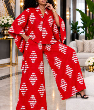A Woman Wearing A Crimson & White Batik Asymmetric Button Poncho And Wide-Leg Cargo Trousers Set.