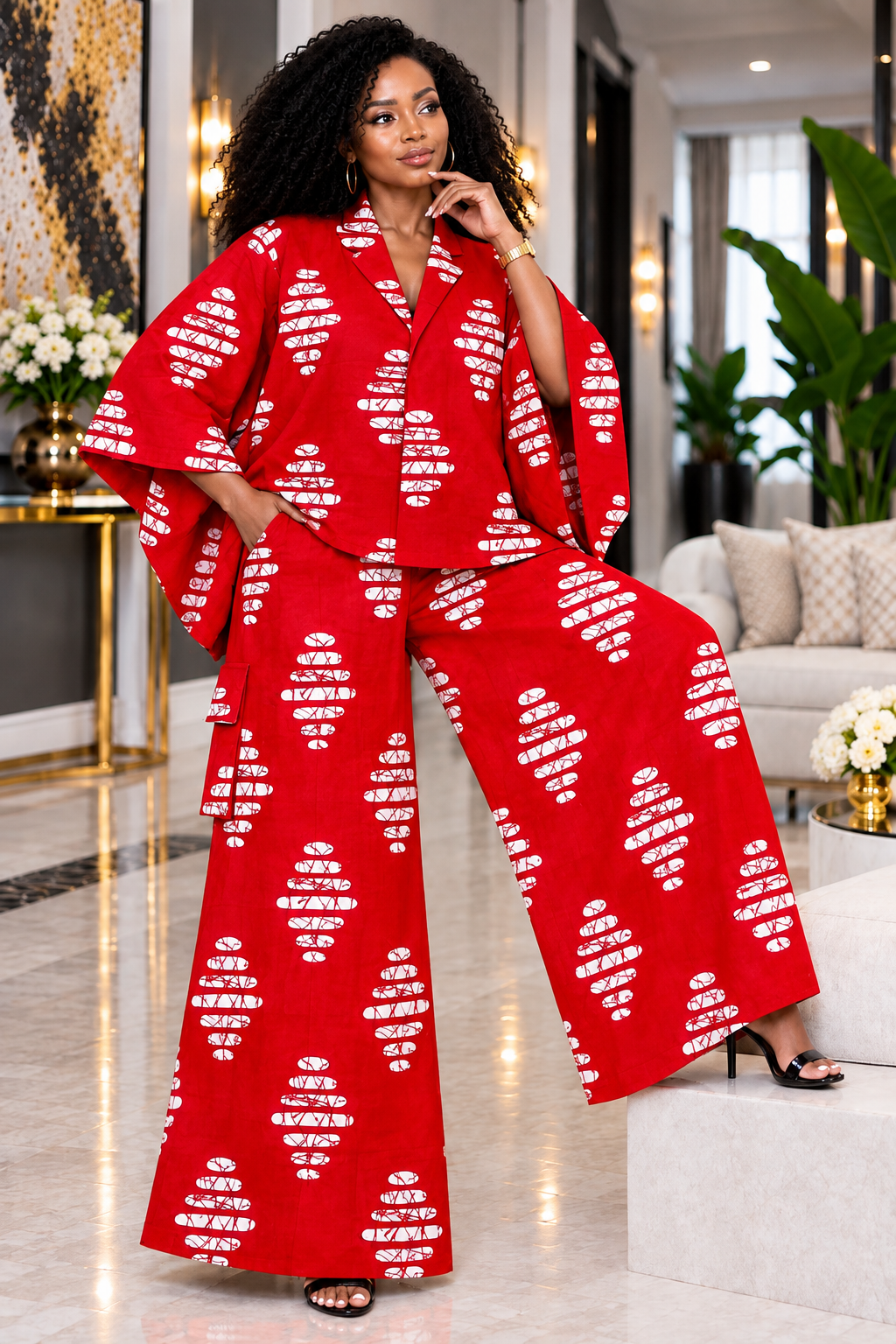 A Woman Wearing A Crimson & White Batik Asymmetric Button Poncho And Wide-Leg Cargo Trousers Set.