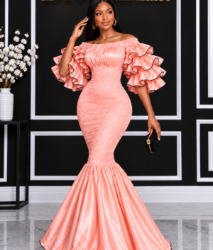 A Woman Wearing An Elastic Luminous Peach Rose Gold Smocked Ruffle Mermaid Gown.