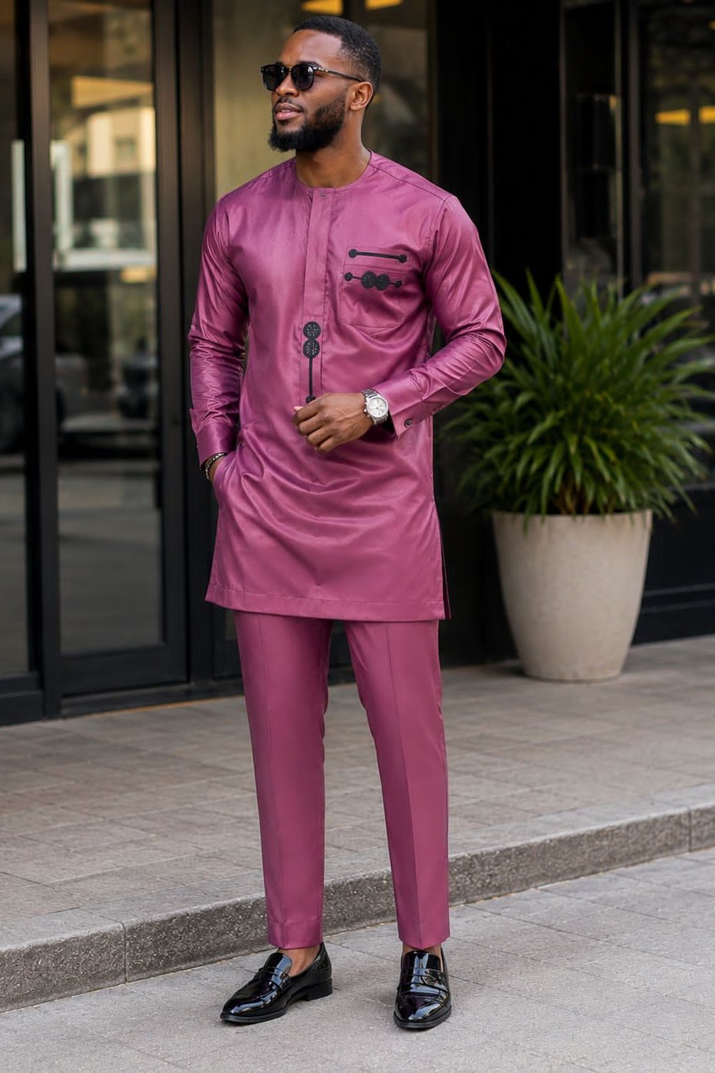 A Man Wearing A Mauve Purple & Charcoal Geometric Accent Senator Tunic And Tailored Pants Set.