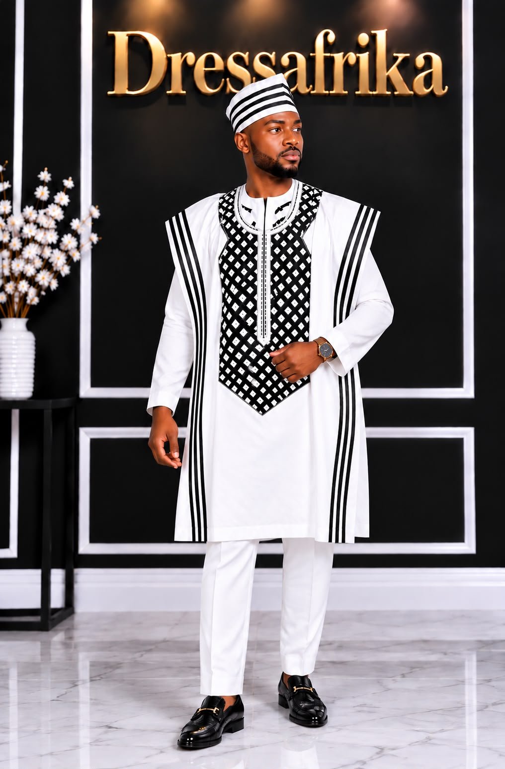 Royal White Alabaster 4-Piece Embroidered Agbada And Long-Sleeve Senator Suit Set With Fila Hat. 2 A Man Wearing A Royal Alabaster 4-Piece Embroidered Agbada And Long-Sleeve Senator Suit Set With Hat.