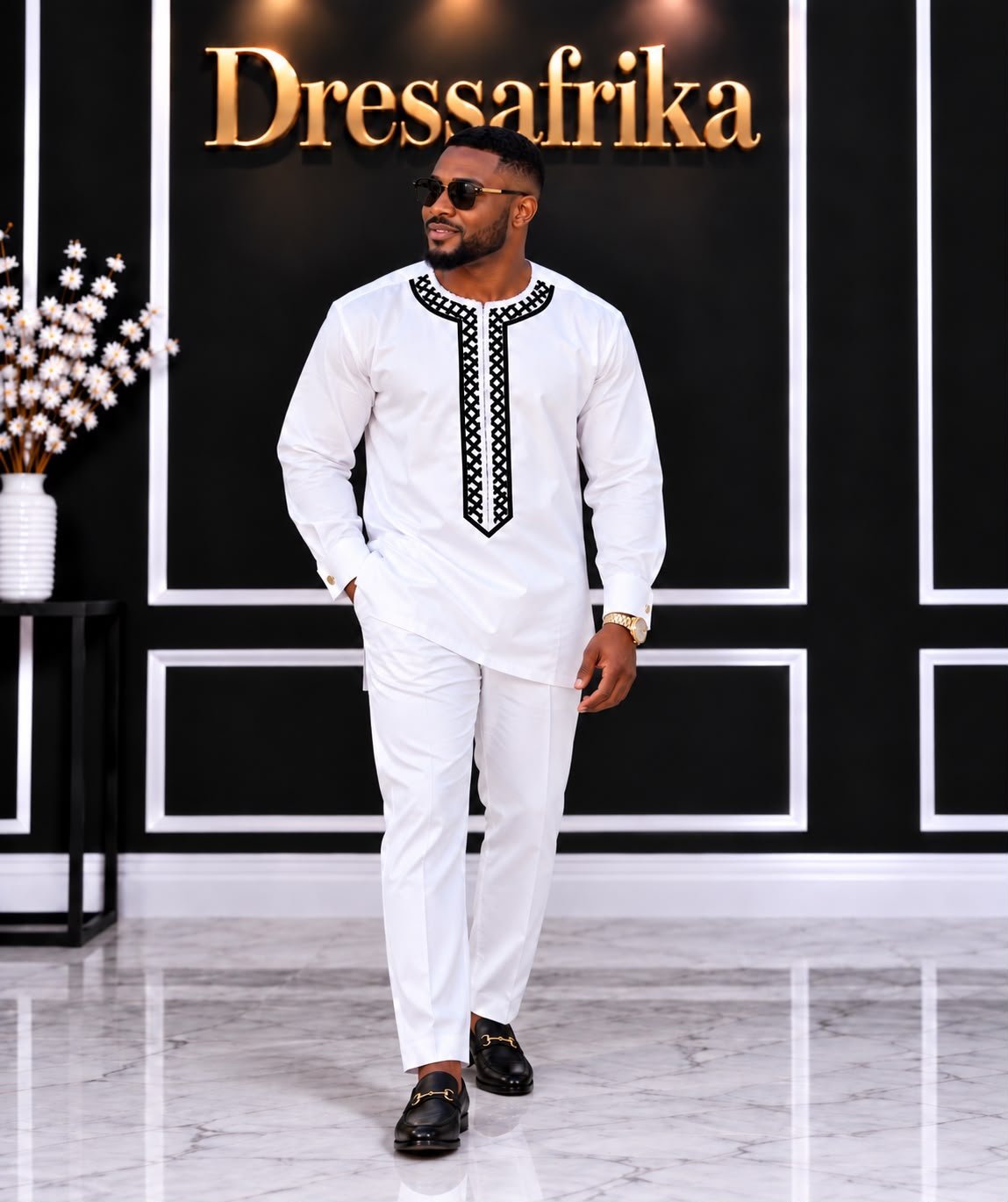 Royal White Alabaster 4-Piece Embroidered Agbada And Long-Sleeve Senator Suit Set With Fila Hat. 4 A Man Wearing A Royal Alabaster 4-Piece Embroidered Agbada And Long-Sleeve Senator Suit Set With Hat.