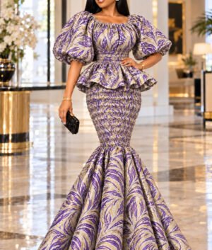 A Woman Wearing An Imperial Elastic Purple & Gold Metallic Jacquard Smocked Peplum Mermaid Gown.