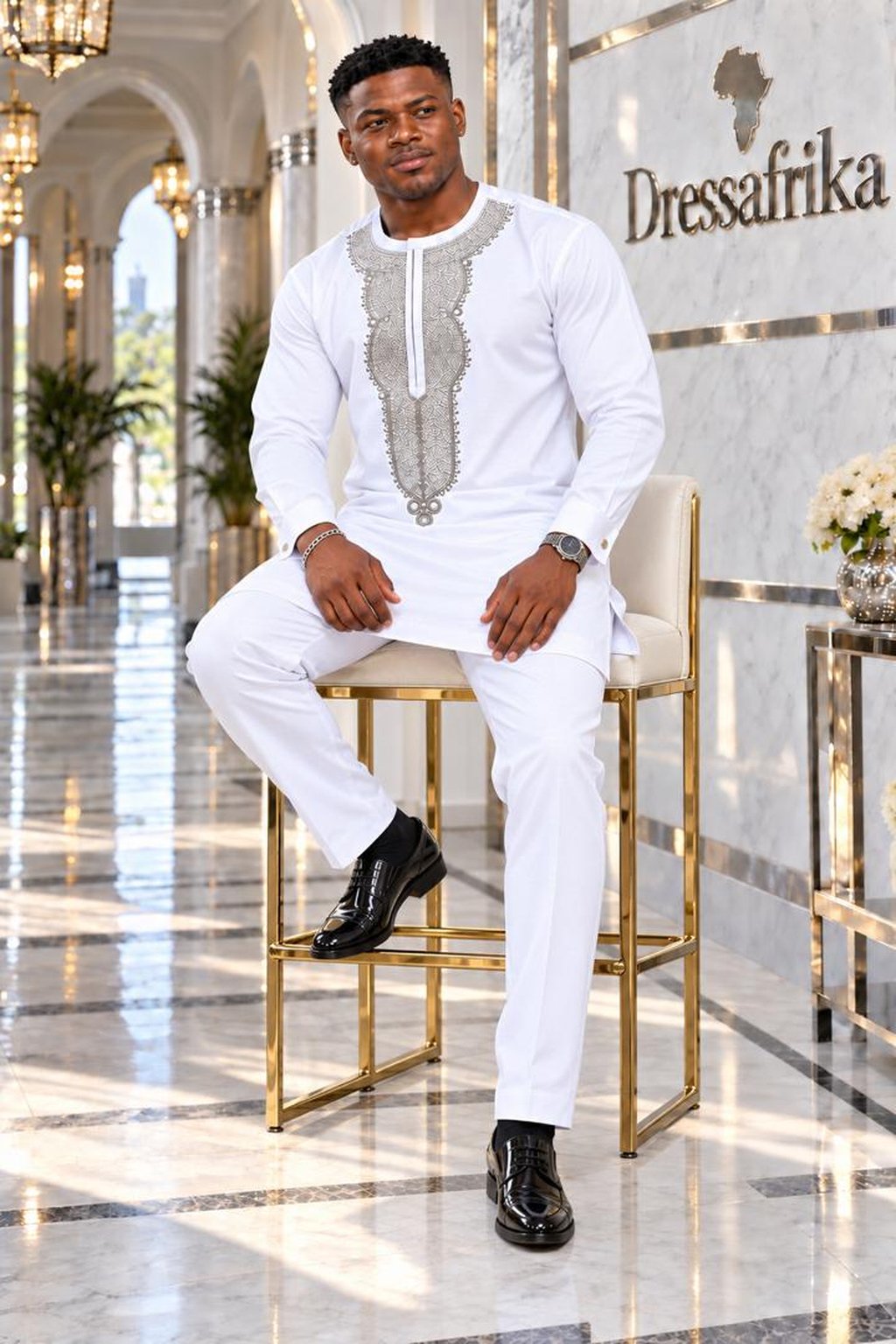 A Man Wearing A Royal Alabaster Embroidered Long-Sleeve Senator Tunic & Pants Set.