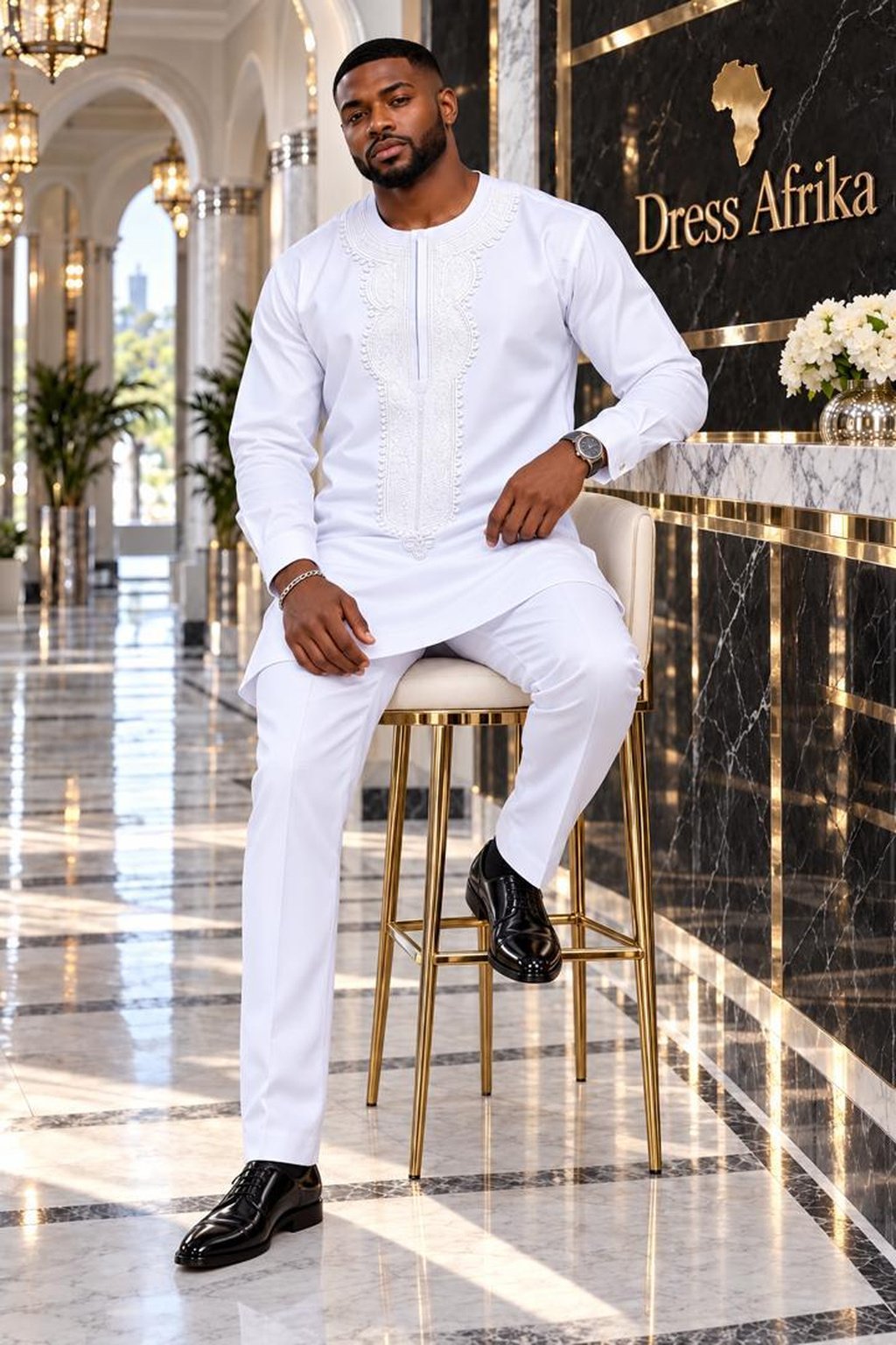 A Man Wearing A Royal Alabaster Embroidered Long-Sleeve Senator Tunic & Pants Set.