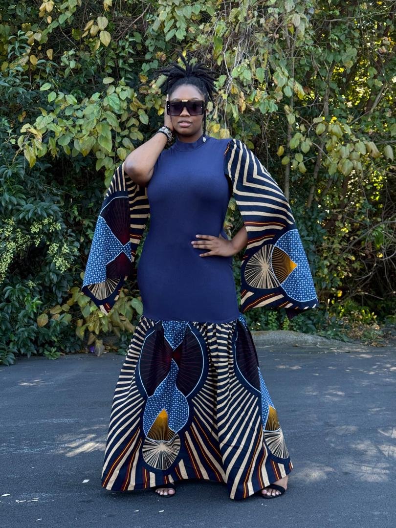 Cobalt Blue Cape Sleeve Ankara Print Mermaid Gown. 2 A Woman Wearing A Cobalt Blue Cape Sleeve Ankara Print Mermaid Gown.