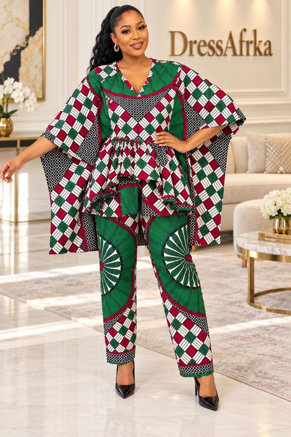 A Woman Wearing A Emerald & Maroon Sunburst Inner-Tie Asymmetric Boubou & Trousers Set.