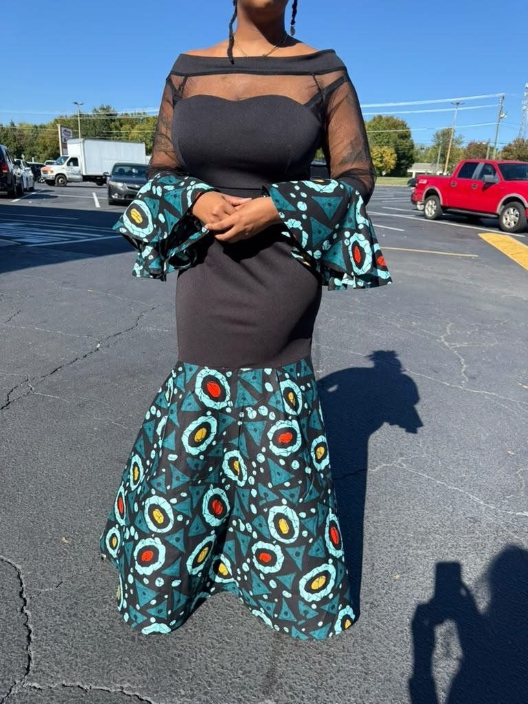Onyx Black Illusion Mesh Ankara Print Knit Dress And Elegant Lace Sleeve Mermaid Gown. 3 A Woman Wearing An Onyx Black Illusion Mesh Ankara Print Knit Dress And Elegant Lace Sleeve Mermaid Gown.