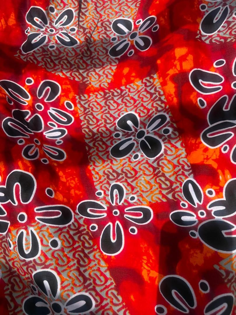 Crimson Blossom Off-Shoulder Ruffle Ankara Two-Piece Maxi Set (With / Without Slit Options). 5 A Woman Wearing A Crimson Blossom Off-Shoulder Ruffle Ankara Two-Piece Maxi Set (With / Without Slit Options).