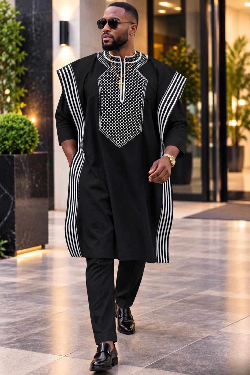 A Man Wearing A Royal Onyx 3-Piece Geometric Embroidered Agbada & Long-Sleeve Senator Suit Set.